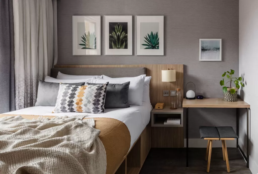 bedroom with bed and bedside table at Inhabit Hotel