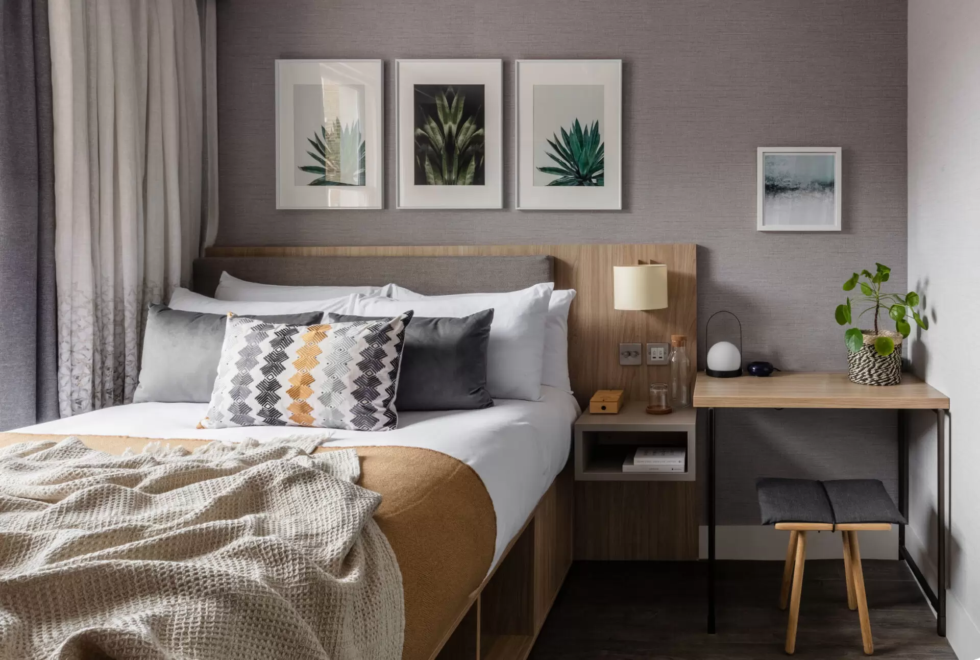 bedroom with bed and bedside table at Inhabit Hotel